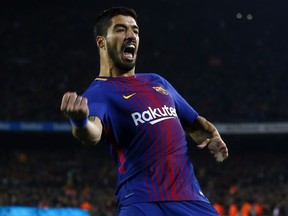 FC Barcelona's Luis Suarez celebrates after scoring during the Spanish Copa del Rey, quarter final, second leg, soccer match between FC Barcelona and Espanyol at the Camp Nou stadium in Barcelona, Spain, Thursday, Jan. 25, 2018.