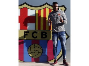 Colombia's soccer player Yerry Mina gestures at the Camp Nou stadium in Barcelona, Spain, Friday, Jan. 12, 2018. A few days after signing Philippe Coutinho to boost its attack, Barcelona strengthened its defense by adding young Colombian international Yerry Mina, a solid defender who is a threat on set-pieces and is known for his slick dance moves during goal celebrations.