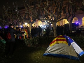 Demonstrators prepare to camp outside the Catalonia parliament in Barcelona, Spain, Tuesday, Jan. 30, 2018. Catalan separatist lawmakers who want to re-elect their fugitive ex-president suffered a setback Tuesday when the house speaker postponed a planned regional parliament meeting, saying it wouldn't take place until there were guarantees Spanish authorities "won't interfere."