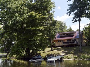 FILE - In this July 27, 2016 photo, the Bobo family's cabin sits on an 8-acre private island in Manchester Township, Mich. The owners have used the 1700-square-foot cabin, which sleeps up to 12, as a rental property.