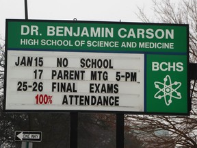 The Dr. Benjamin Carson information sign is seen outside the school, Wednesday, Jan. 10, 2018. The Detroit Board of Education approved a new policy Tuesday that allows the district to rename buildings already named after living people. The new policy on naming and remaining schools in the district, approved in a 4-3 vote, says in part the board may change the name of a school for reasons that "the school community's opinion that the name of the school no longer represents the culture or population of the geographic area in which the school is located."