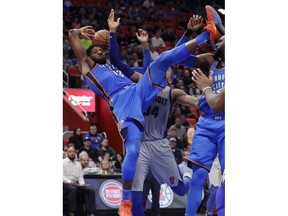 Oklahoma City Thunder forward Paul George (13) falls after Detroit Pistons forward Tobias Harris (34) deflected the ball out of his control during the second half of an NBA basketball game Saturday, Jan. 27, 2018, in Detroit.