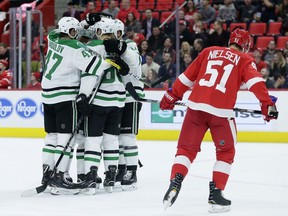 Dallas Stars center Jason Spezza, second from left, celebrates his goal with teammates, including Dallas Stars right wing Alexander Radulov (47), of Russia, as Detroit Red Wings center Frans Nielsen (51), of Denmark, skates off during the first period of an NHL hockey game Tuesday, Jan. 16, 2018, in Detroit.