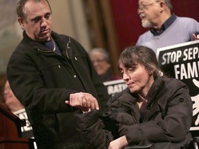 In a Tuesday, Jan. 16, 2018 photo, Ded Rranxburgaj holds his wife Flora's hand during a press conference after taking sanctuary at Central United Methodist Church while facing deportation in Detroit. Central United Methodist Church is offering sanctuary to Rranxburgaj of Southgate, who is scheduled to be deported Jan. 25. Rranxburgaj and his wife Flora Rranxburgaj, both from Albania, immigrated to the U.S. 17 years ago and applied for refugee status within 5 months of their arrival. Eleven years ago Flora fell ill with Multiple Sclerosis and her husband Ded has had to take care of her since.