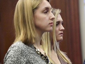 FILE- In this Jan. 19, 2018, file photo, sisters Kara, left, and Maddie Johnson make their victim impact statements in Lansing, Mich., during the fourth day of sentencing for former sports doctor Larry Nassar, who pled guilty to multiple counts of sexual assault.