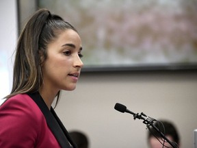 FILE- In this Jan. 19, 2018, file photo, Olympic gold medalist Aly Raisman gives her victim impact statement in Lansing, Mich., during the fourth day of sentencing for former sports doctor Larry Nassar, who pled guilty to multiple counts of sexual assault.
