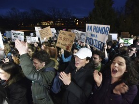 Demonstrators gather at "The Rock" on Michigan State University's East Lansing, Mich., campus to support victims of disgraced former sports doctor Larry Nassar and call for more changes in leadership at the university.