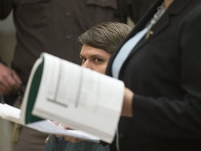 James Chelekis listens as his attorney, Shawn Perry, reads aloud at the Kent County Courthouse in downtown Grand Rapids, Mich., on Tuesday, Jan. 23, 2018.  Chelekis, a former teacher has been sentenced to 30 to 60 years in prison for slashing his wife's throat after she discovered he was having an affair with someone who turned out to be a middle-school student.