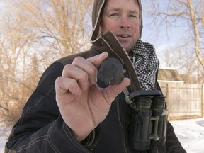 Robert Ward holds what he claims is the largest of three meteorites he's found in a cluster on a lake in Hamburg Township, Mich., Thursday, Jan. 18, 2018. Ward works with teams that travel the world in search of meteorites.