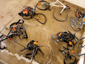 FILE- In this June 9, 2016 file photo, mangled bicycles are tagged as evidence at the Michigan State Police crime lab in Kalamazoo, Mich. A pickup truck plowed into the cyclists on a rural road near Kalamazoo. While other states adopted bike-friendly safety laws to accommodate cycling's soaring popularity, Michigan lawmakers are trying to make up for lost time by seeking some of the nation's strictest bike-safety regulations and tough new penalties for distracted motorists who cause serious injury or death while using a mobile device.