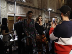 Models wait backstage prior to the start of Versace men's Fall-Winter 2018-19 collection, that was presented in Milan, Italy, Saturday, Jan.13, 2018.