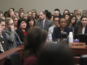 People in the gallery react, along with prosecuting team, as Kaylee Lornicz gives her impact statement, during the seventh day of Larry Nassar's sentencing hearing, Wednesday, Jan. 24, 2018, in Lansing, Mich.  Nassar, the former sports doctor who admitted molesting some of the nation's top gymnasts for years was sentenced Wednesday to 40 to 175 years in prison as the judge declared: "I just signed your death warrant."  The sentence capped a remarkable seven-day hearing in which scores of Nassar's victims were able to confront him face to face in the Michigan courtroom.