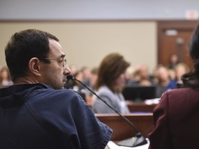 Larry Nassar sits in court during a sentencing hearing Thursday, Jan. 18, 2018, waiting for the third day of victim impact statements to begin, in Lansing, Mich. Nassar, 54, faces a minimum sentence of 25 to 40 years in prison for molesting girls at Michigan State University and his home. He also was a team doctor at USA Gymnastics, based in Indianapolis, which trains Olympians. He's already been sentenced to 60 years in federal prison for child pornography crimes.