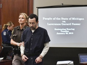 Larry Nassar is brought into court Tuesday, Jan. 23, 2018, in Lansing, Mich.  Nassar, 54, has admitted sexually assaulting athletes under the guise of medical treatment when he was employed by Michigan State University and USA Gymnastics, which as the sport's national governing organization trains Olympians. He already has been sentenced to 60 years in prison for child pornography. Under a plea bargain, he faces a minimum of 25 to 40 years behind bars in the molestation case.