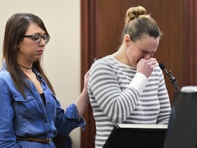 Clasina Syrovy takes a moment to regain her composure Monday, Jan. 22, 2018, during the fifth day of victim impact statements against Larry Nassar in Ingham County Circuit Court in Lansing, Mich. Nassar has admitted molesting athletes during treatment when he was employed by Michigan State University and USA Gymnastics, which trains Olympians. He will be sentenced on sexual assault charges this week.