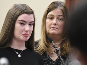 Emma Ann Miller, 15, speaks  Monday, Jan. 22, 2018, during the fifth day of victim impact statements against Larry Nassar in Ingham County Circuit Court in Lansing, Mich. Nassar will be sentenced on sexual assault charges this week. Next to her is her mother Leslie. Nassar has admitted molesting athletes during treatment when he was employed by Michigan State University and USA Gymnastics, which trains Olympians. He will be sentenced on sexual assault charges this week.