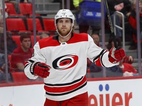 Carolina Hurricanes center Elias Lindholm celebrates his goal against the Detroit Red Wings in the first period of an NHL hockey game Saturday, Jan. 20, 2018, in Detroit.