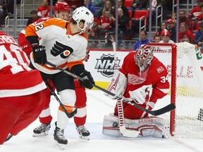 Detroit Red Wings goaltender Petr Mrazek (34) stops a Philadelphia Flyers left wing Michael Raffl (12) shot in the first period of an NHL hockey game Tuesday, Jan. 23, 2018, in Detroit.