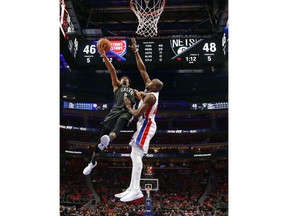 Brooklyn Nets guard Spencer Dinwiddie (8) drives on Detroit Pistons forward Anthony Tolliver in the first half of an NBA basketball game in Detroit, Sunday, Jan. 21, 2018.