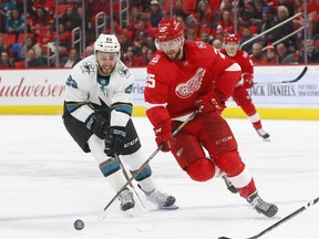 San Jose Sharks right wing Barclay Goodrow (23) and Detroit Red Wings defenseman Mike Green (25) battle for the puck in the second period of an NHL hockey game Wednesday, Jan. 31, 2018, in Detroit.