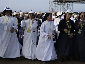 Nuns sing as they wait for the arrival of Pope Francis to celebrate Mass on Huanchaco Beach, near the city of Trujillo, Peru, Saturday, Jan. 20, 2018. Francis travels Saturday to northern Peru, where the pontiff will celebrate Mass and ride through a hard-hit neighborhood still reeling from disastrous rains that hit nearly a year ago.