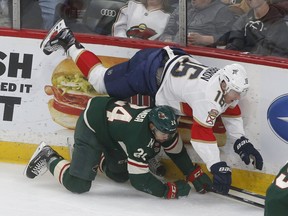 Florida Panthers' Aleksander Barkov, top, of Finland, topples over Minnesota Wild's Matt Dumba during the first period of an NHL hockey game Tuesday, Jan. 2, 2018, in St. Paul, Minn.