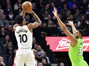 Toronto Raptors' DeMar DeRozan, left, shoots over Minnesota Timberwolves' Karl-Anthony Towns in the first half of an NBA basketball game Saturday, Jan. 20, 2018, in Minneapolis.