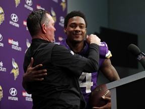Minnesota Vikings head coach Mike Zimmer greets wide receiver Stefon Diggs (14) during a press conference following a 29-24 win over the New Orleans Saints an NFL divisional football playoff game in Minneapolis, Sunday, Jan. 14, 2018.