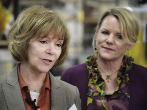 FILE - In this Jan. 5, 2018, file photo, U.S. Sen. Tina Smith, D-Minn., left, speaks alongside Wyoming Machine Inc. co-president Lori Tapani, in Stacy, Minn. Smith has no time to waste as she prepares for the U.S. Senate and a November election to keep her new job. She was appointed to replace Al Franken, who resigned after allegations of sexual misconduct. Smith was sworn in Wednesday.