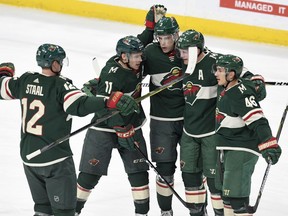 Minnesota Wild, from left, Eric Staal, Zach Parise, Charlie Coyle, Ryan Suter and Jared Spurgeon celebrate Spurgeon's goal in the first period of an NHL hockey game Saturday, Jan. 20, 2018, in St. Paul, Minn.