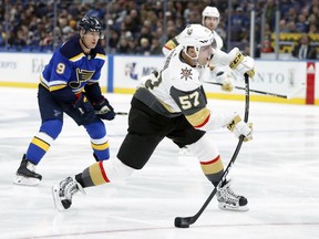 Vegas Golden Knights' David Perron (57) shoots as St. Louis Blues' Scottie Upshall (9) watches during the first period of an NHL hockey game Thursday, Jan. 4, 2018, in St. Louis.