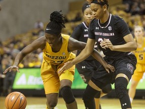 Missouri's Amber Smith, left, and South Carolina's Lele Grissett, right, battle for the ball during the first half of an NCAA college basketball game Sunday, Jan. 7, 2018, in Columbia, Mo.