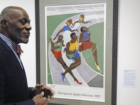 In this Jan. 11, 2018 photo, Alan Page, NFL Hall of Famer and retired Minnesota Supreme Court justice, talks about a poster from the 1972 Olympics in Munich that was done by an African-American artist, which is among the artifacts of slavery and segregation collected by Page and his wife, Diane Sims Page. They went on display at the Minneapolis Central Library in time for Super Bowl visitors and thousands of other people expected to flock to downtown for the festivities.