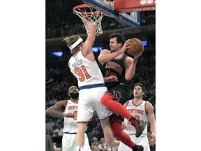 Chicago Bulls forward Paul Zipser (16) goes up with the ball as he is guarded by New York Knicks guard Ron Baker (31) during the second quarter of an NBA basketball game Wednesday, Jan. 10, 2018, at Madison Square Garden in New York.