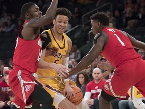 Ohio State forward Jae'Sean Tate (1) and forward Andre Wesson (24) guard Minnesota guard Amir Coffey (5) during the first half of an NCAA college basketball game, Saturday, Jan. 20, 2018, at Madison Square Garden in New York.