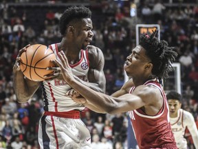 Mississippi's Terence Davis II is defended by Alabama's Herbert Jones (10) during an NCAA college basketball game in Oxford, Miss. on Tuesday, Jan. 23, 2018.