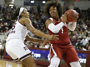Alabama forward Quanetria Bolton (1) tries to keep the ball away from Mississippi State guard Victoria Vivians (35) during the first half of an NCAA college basketball game in Starkville, Miss., Sunday, Jan. 14, 2018.