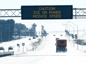 Motorists along Interstate 49 are prompted to heed the overhead warning sign of the danger of icy roads in Hattiesburg, Miss., Wednesday, Jan. 17, 2018, as communities in the southern part of the state began to thaw out following a hard freeze that affected much of the state, Wednesday, Jan. 17, 2018. Several inches of snow fell along the Mississippi Delta, the northern part of the state and down along the Louisiana-Mississippi border.