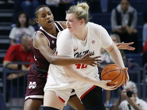 Mississippi State center Zion Campbell (25) wraps up Mississippi forward Shelby Gibson (42) as she looks for an open teammate during the second half of the NCAA college basketball game in Oxford, Miss., Sunday, Jan. 28, 2018. Mississippi State won 69-49.