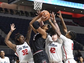 South Carolina forward A'ja Wilson (22) takes a shot past Mississippi forwards Kate Rodgers (32), Shelby Gibson (42) and guard Chyna Nixon (0) during the first half of an NCAA college basketball game in Oxford, Miss., Thursday, Jan. 4, 2018.