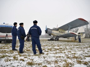 Police officers survey an Ukranian-registered AN-2 aircraft near Kallosemjen, 242 kms east of Budapest, Hungary, Wednesday, Jan. 17, 2018, after the plane carrying 11 migrants entered Hungarian air space and landed on an agricultural area. The migrants, comprising three Afghan and eight Vietnamese nationals, were apprehended near Kallosemjen following an extensive search that included the use of search dogs and thermal cameras. Police are investigating the incident as a human smuggling case.