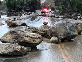 Boulders block a road following a mudslide due to heavy rain falls in Montecito, California, on Jan. 9, 2018.