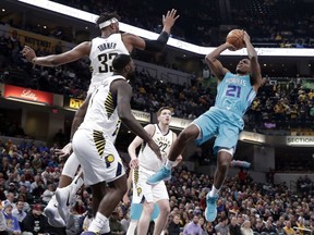 Charlotte Hornets guard Treveon Graham (21) jumps to shoot over Indiana Pacers center Myles Turner (33) during the first half of an NBA basketball game in Indianapolis, Monday, Jan. 29, 2018.
