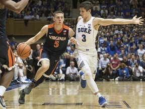 Virginia's Kyle Guy (5) handles the ball against the defense of Duke's Grayson Allen (3) during the second half of an NCAA college basketball game in Durham, N.C., Saturday, Jan. 27, 2018. Virginia defeated Duke 65-63.