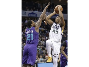 Utah Jazz's Donovan Mitchell (45) shoots over Charlotte Hornets' Treveon Graham (21) during the first half of an NBA basketball game in Charlotte, N.C., Friday, Jan. 12, 2018.