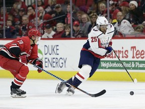 Carolina Hurricanes' Sebastian Aho (20), of Finland, chases Washington Capitals' Devante Smith-Pelly (25) during the first period of an NHL hockey game in Raleigh, N.C., Tuesday, Jan. 2, 2018.