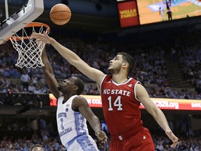 North Carolina's Theo Pinson (1) drives to the basket while North Carolina State's Omer Yurtseven (14) defends during the first half of an NCAA college basketball game in Chapel Hill, N.C., Saturday, Jan. 27, 2018.