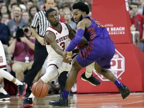 North Carolina State's Lavar Batts Jr. (3) and Clemson's Gabe DeVoe (10) chase the ball during the first half of an NCAA college basketball game in Raleigh, N.C., Thursday, Jan. 11, 2018.