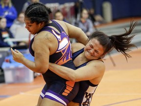 In this Jan. 27, 2018 photo, Midland University's Leilani Camargo-Naone, right, wrestles Missouri Valley College's Alyssa Cantu during a bout at the Kansas Collegiate Athletic Conference championships in Fremont, Neb. Leilani Camargo-Naone represents Midland's best chance for a national title. The sophomore from Wai'anae, on the west side of Oahu, is ranked No. 4 in the nation at 191 and was the only Midland wrestler to win a conference championship. She's 61-9 with 40 pins in her career.
