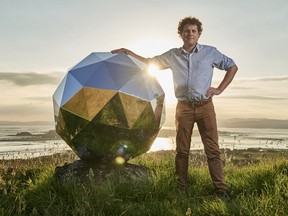 In this Nov. 2017 photo provided by Rocket Lab, Rocket Lab founder and CEO Peter Beck is pictured with his "Humanity Star" in Auckland, New Zealand. Beck, the founder of the company that this week launched the first rocket into orbit from New Zealand said on Wednesday, Jan 24, 2018, that he had deployed a secret satellite he believes will be the brightest object in the night sky and which he hopes will remind people of their precarious place in a vast universe.